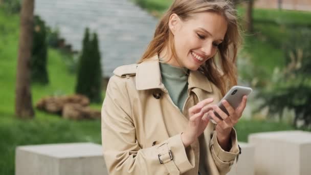 Beautiful Smiling Girl Looking Happy Checking Social Networking Smartphone Outdoor — Stock Video