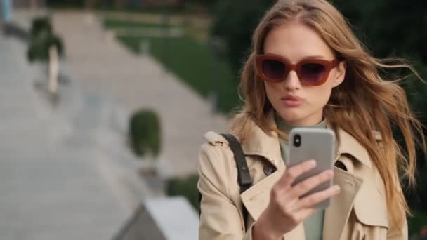 Vacker Snygg Student Flicka Bär Solglasögon Och Trenchcoat Tar Selfie — Stockvideo