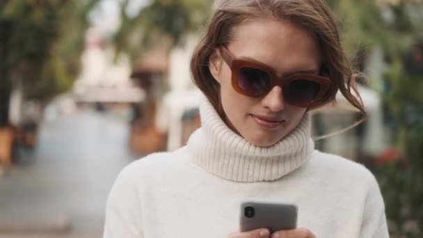 Tracking Shot Beautiful Stylish Girl Sunglasses Dressed White Cozy Sweater — Stock Video