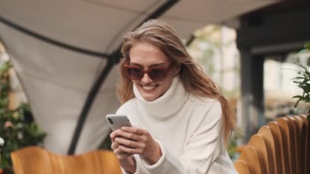 Beautiful Cheerful Girl Sunglasses Dressed Cozy White Sweater Looking Happy — Stock Video