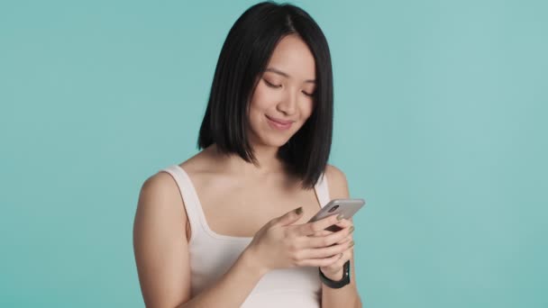 Pretty Positive Asian Girl Browsing Social Network Looking Happy Blue — Stock Video