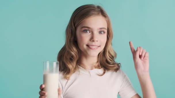 Pretty Smiling Blond Teenage Girl Holding Glass Milk Keeping Thumb — Stock Video