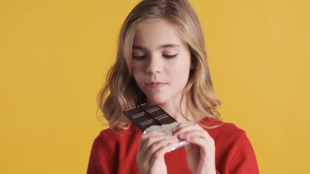 Menina Adolescente Loira Bonita Mordendo Barra Chocolate Olhando Câmera Sobre — Vídeo de Stock