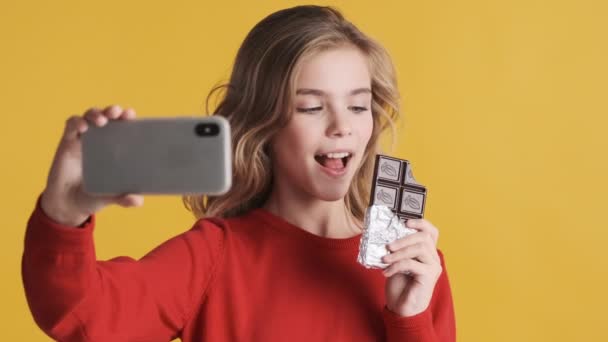 Menina Adolescente Muito Loira Levando Selfie Smartphone Posando Com Chocolate — Vídeo de Stock