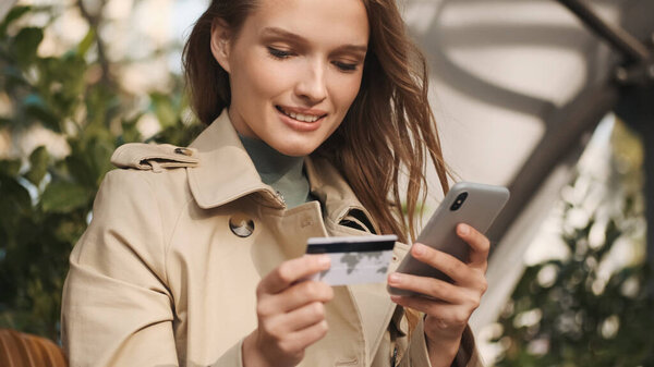 Young Attractive Woman Paying Online Purchases Credit Card Using Smartphone Royalty Free Stock Images