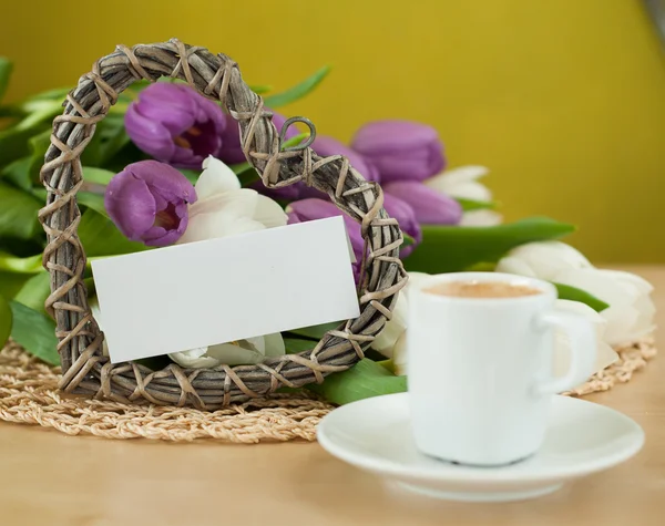 Tulips on the table with cup of caffee — Stock Photo, Image