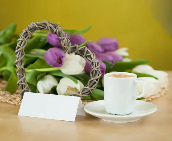 Tulips on the table with cup of caffee — Stock Photo, Image