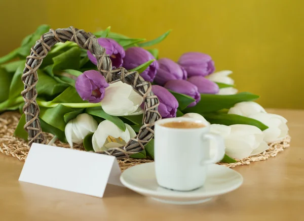 Tulips on the table with cup of caffee — Stock Photo, Image
