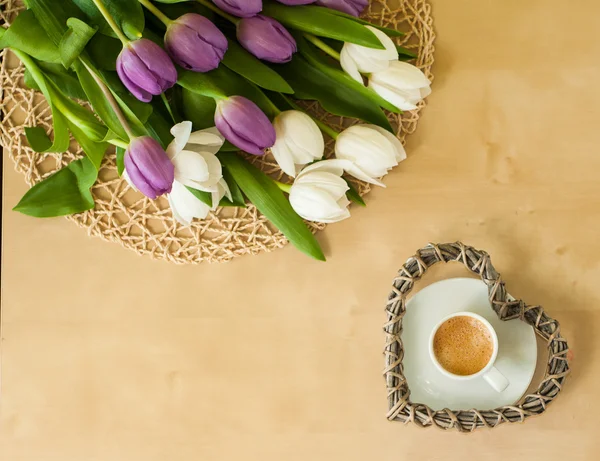 Tulips on the table with cup of caffee — Stock Photo, Image