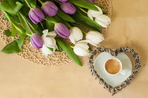 Tulips on the table with cup of caffee — Stock Photo, Image