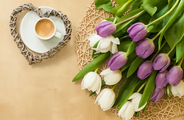 Tulips on the table with cup of caffee — Stock Photo, Image