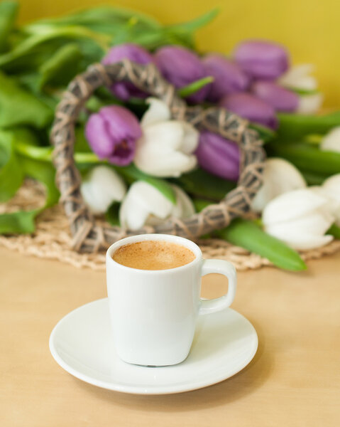 tulips on the table with cup of caffee