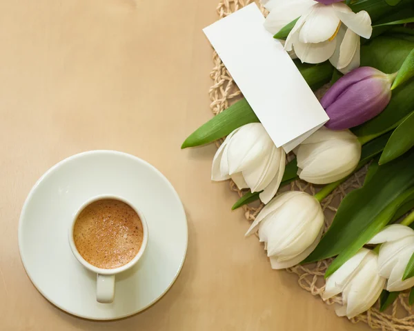 Tulips on the table with cup of caffee — Stock Photo, Image