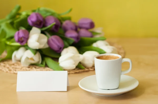 Tulips on the table with cup of caffee — Stock Photo, Image