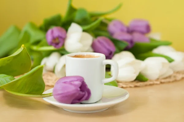 Tulips on the table with cup of caffee — Stock Photo, Image