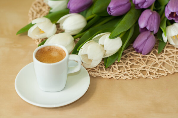 tulips on the table with cup of caffee