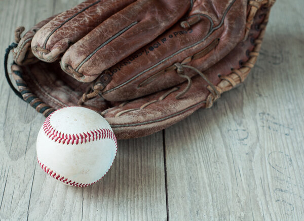 Old and worn used leather baseball sport glove over aged