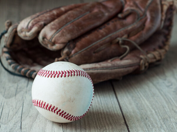 Old and worn used leather baseball sport glove over aged