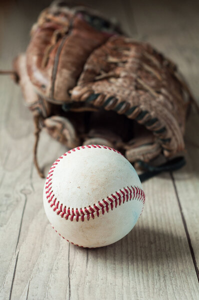 Old and worn used leather baseball sport glove over aged