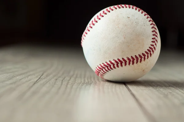 Old baseball on wooden background and highly closeup — Stock Photo, Image