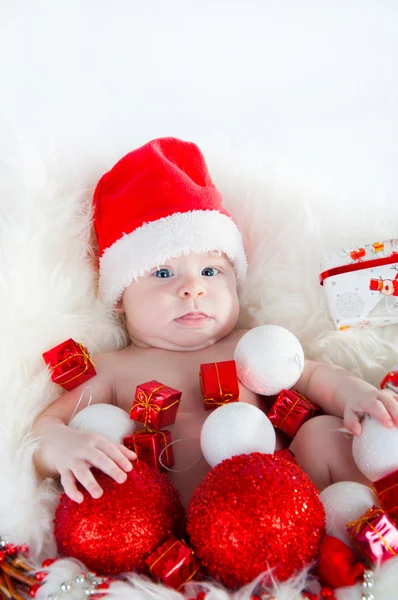 Cute baby Santa lying in a basket — Stock Photo, Image