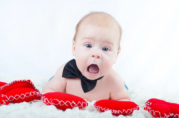 Little beautiful boy in bow tie and with red heart — Stock Photo, Image