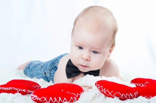 Little beautiful boy in bow tie and with red heart — Stock Photo, Image