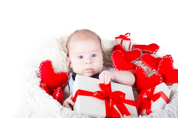 Boy with a gift box and hearts — Stock Photo, Image