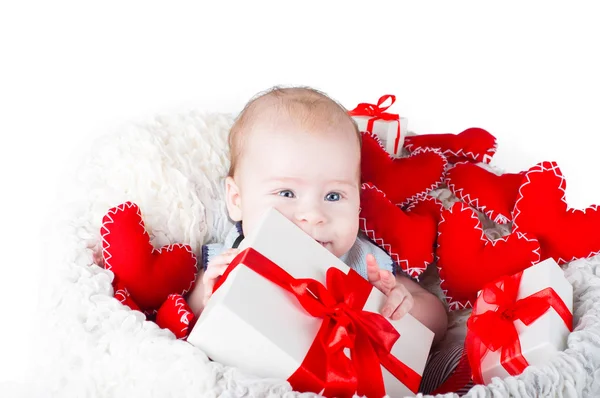 Boy with a gift box and hearts — Stock Photo, Image