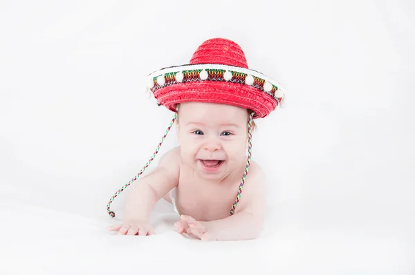 Vrolijk jongetje met een sombrero en maracas op een witte achtergrond Stockfoto