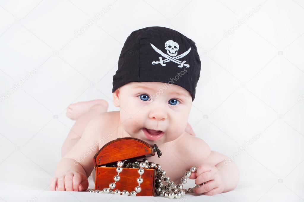 Child boy in pirate bandana with treasure chest on white background