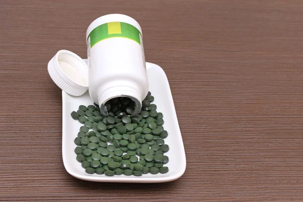 Spirulina tablets plate — Stock Photo, Image