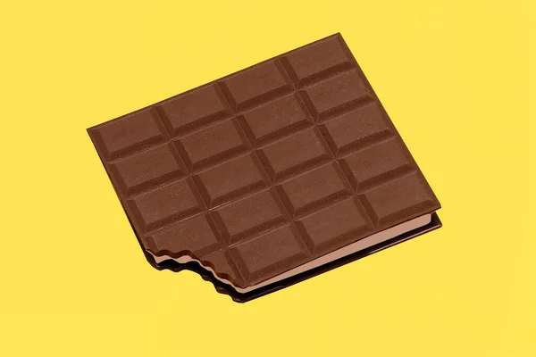 Milk Chocolate Bar Bite Corner Isolated Yellow Background — Stock Photo, Image