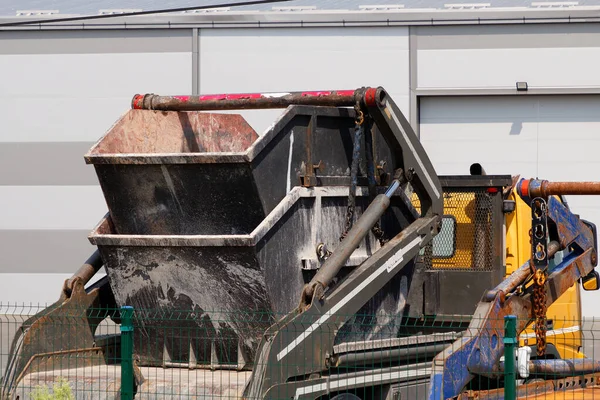 Double skimp dump metal containers used for disposal of  dig up waste material in construction industry while working outside on street