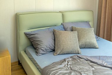 Modern comfortable bed interior with soft silk pillows