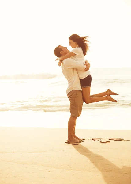 Ρομαντικό ζευγάρι στην παραλία στο ηλιοβασίλεμα. — Φωτογραφία Αρχείου