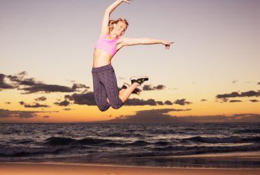 gün batımında sahilde atlayarak kadın