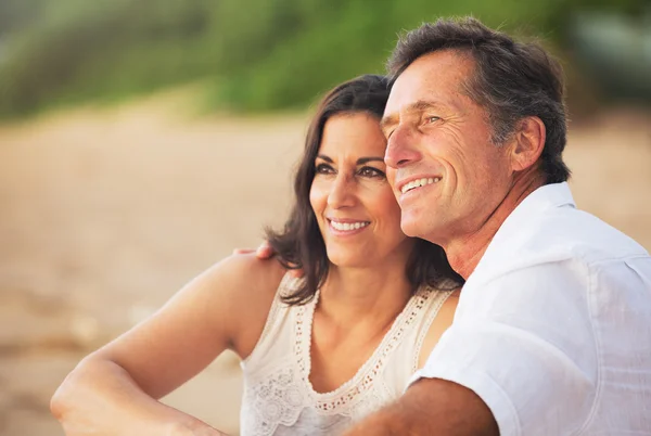 Mature Couple Enjoying Sunset on the Beach Stock Photo