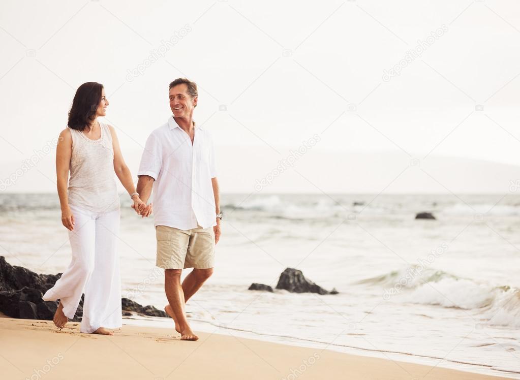 Mature Couple Enjoying Sunset on the Beach