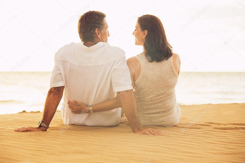 Mature Couple Enjoying Sunset on the Beach