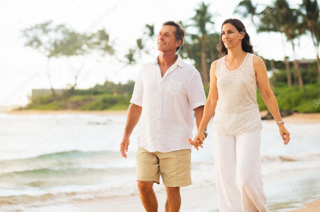 Mature Couple Enjoying Walk on the Beach