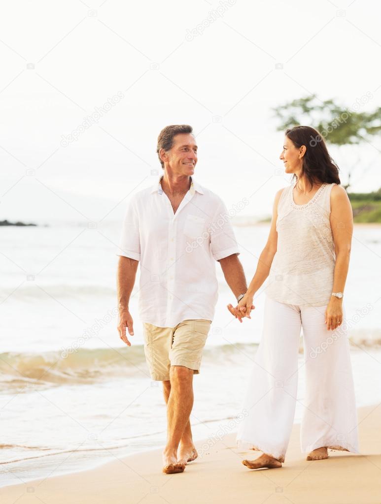 Mature Couple Enjoying Walk on the Beach