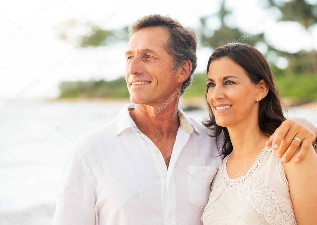 Mature Couple Enjoying Walk on the Beach