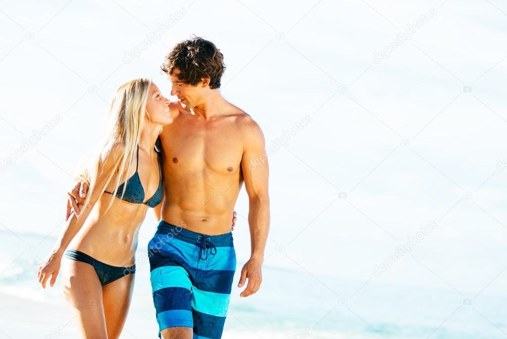 Attractive Couple Walking on Tropical Beach