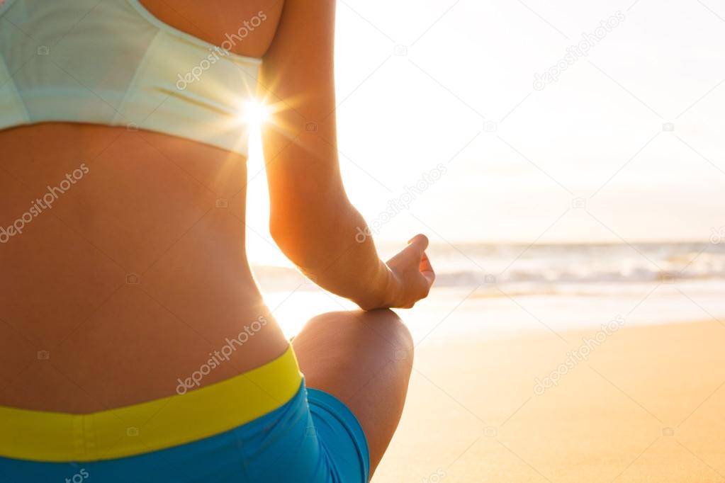 Woman Practicing Yoga on the Beach at Sunset