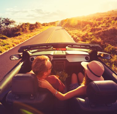 Couple Driving Convertable at Sunset clipart