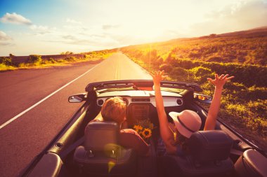 Couple Driving Convertable at Sunset clipart