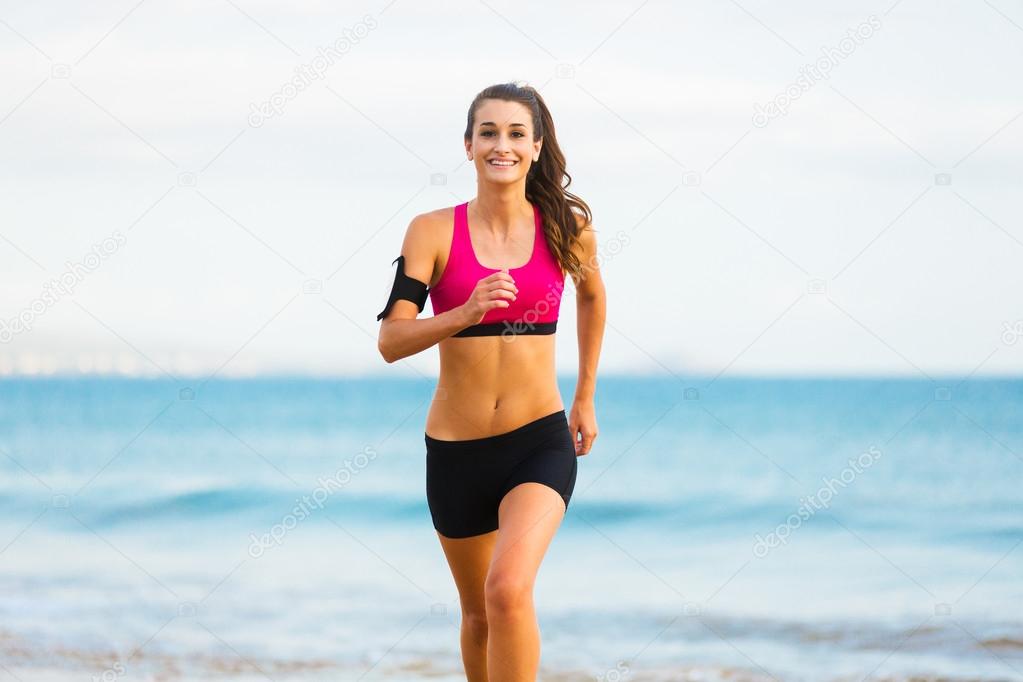 Sports Fitness Woman Running on the Beach