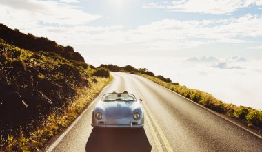 Coupe Driving on Country Road in Vintage Sports Car clipart