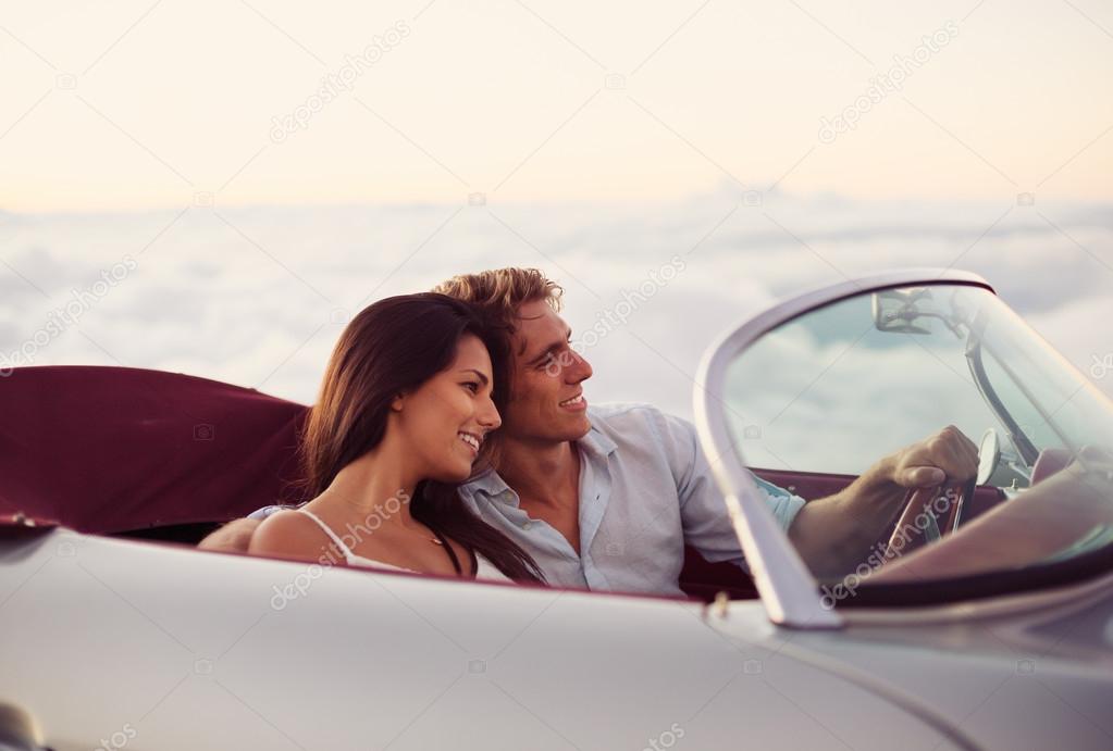 Couple Watching the Sunset in Classic Vintage Car